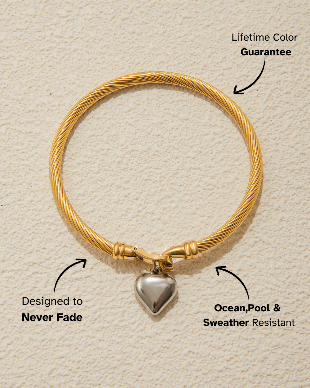 Gold bracelet with a heart-shaped charm on a beige background