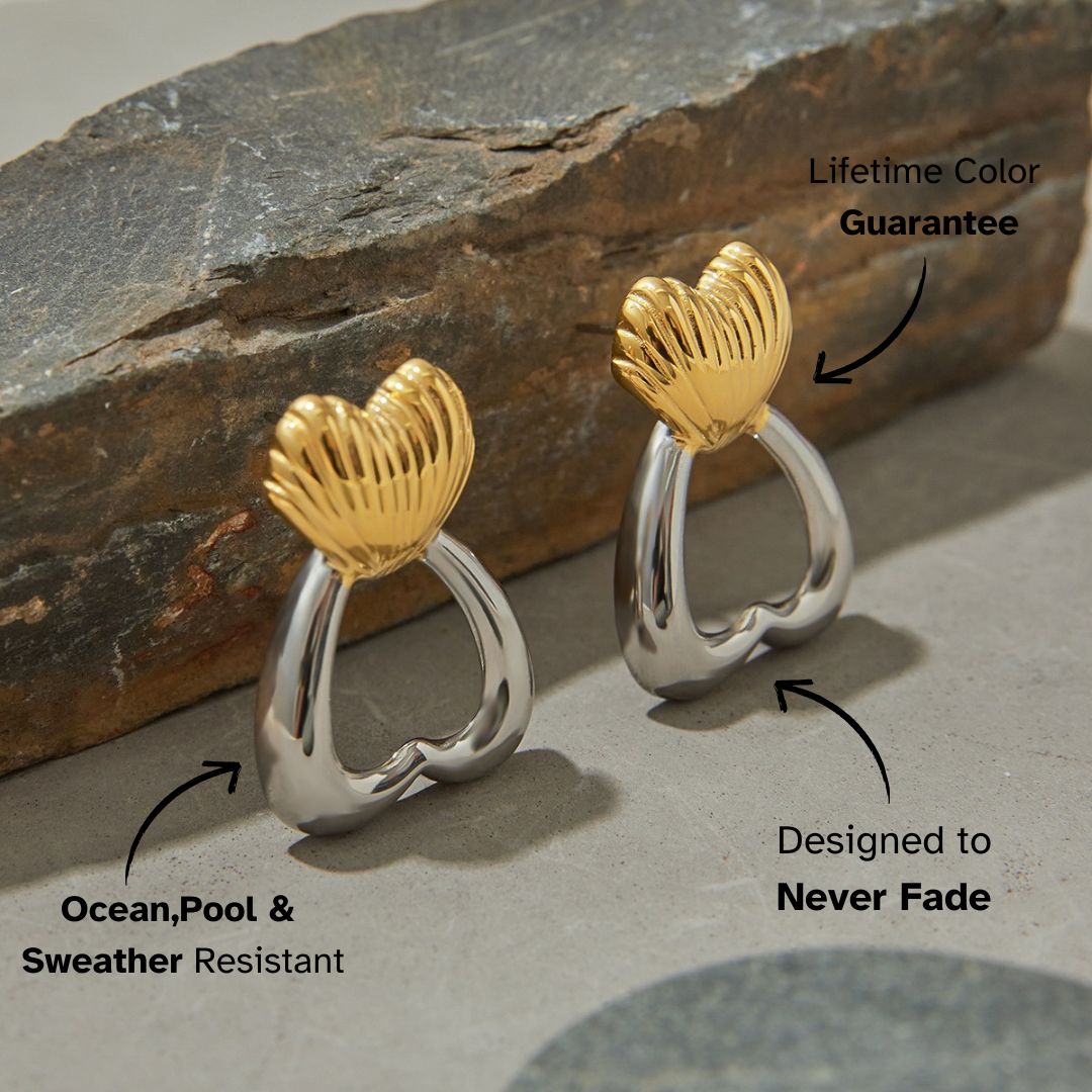 Geometric heart earrings displayed on natural stone background