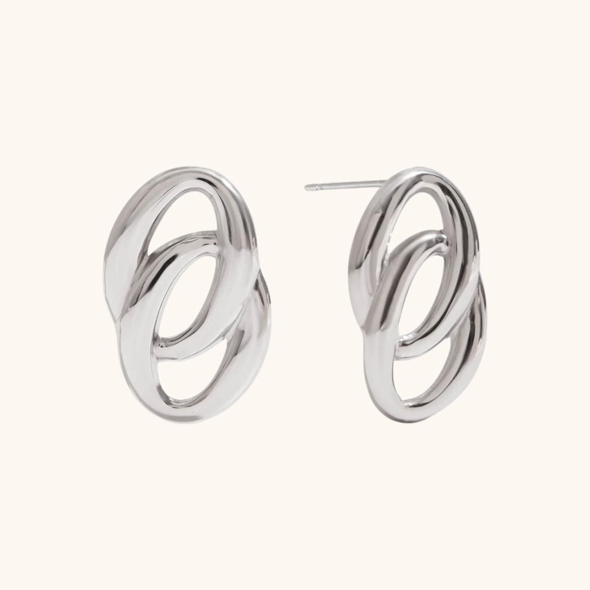 Front-facing view of polished silver interlocking earrings on light background