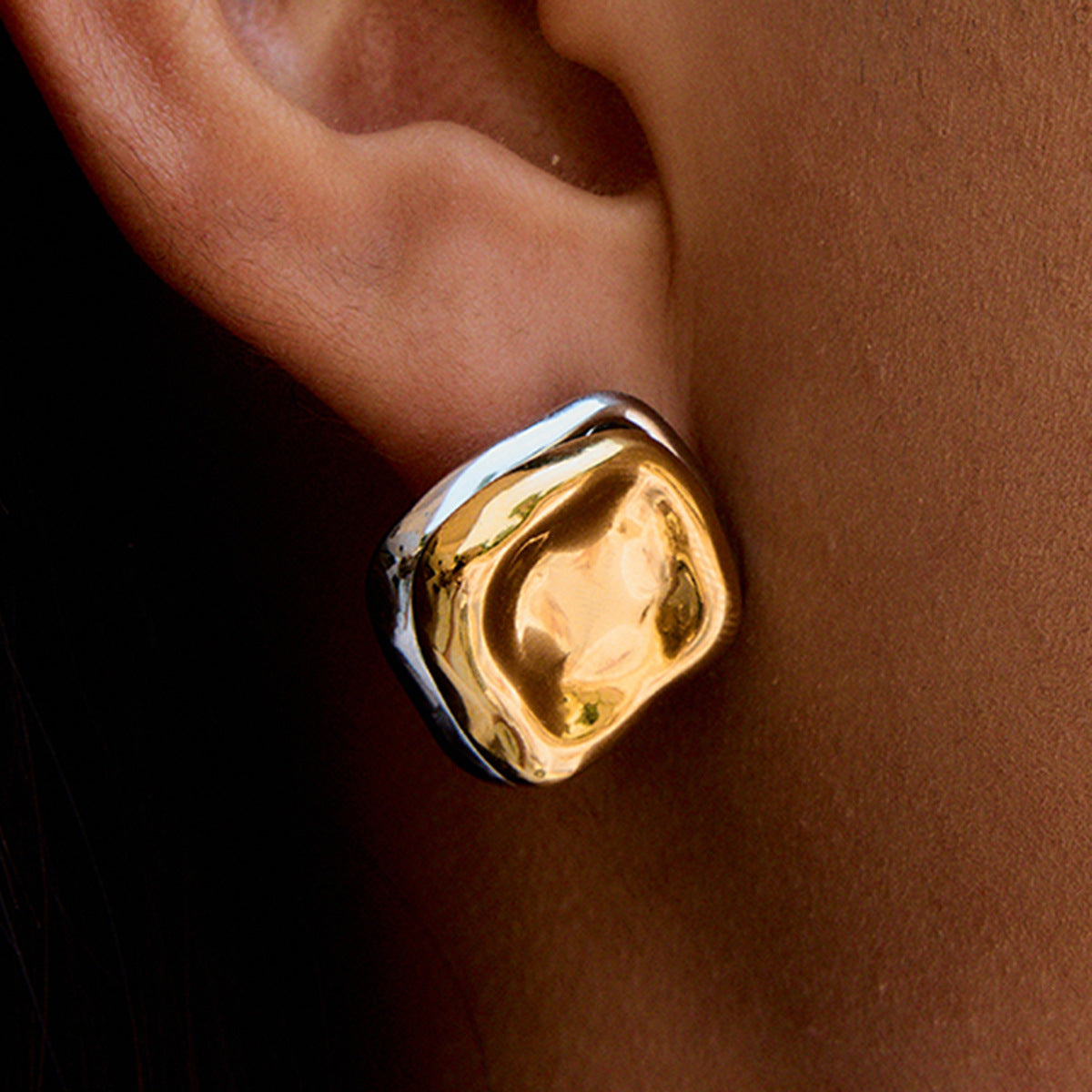 bold asymmetric square earrings worn on model with natural makeup