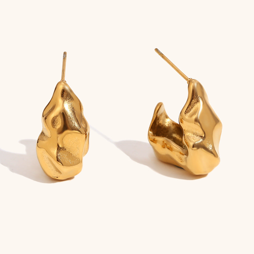 Sculptural molten-style gold hoop earrings with fluid texture