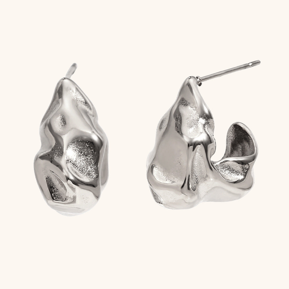 Side profile of gold molten-effect hoop earrings