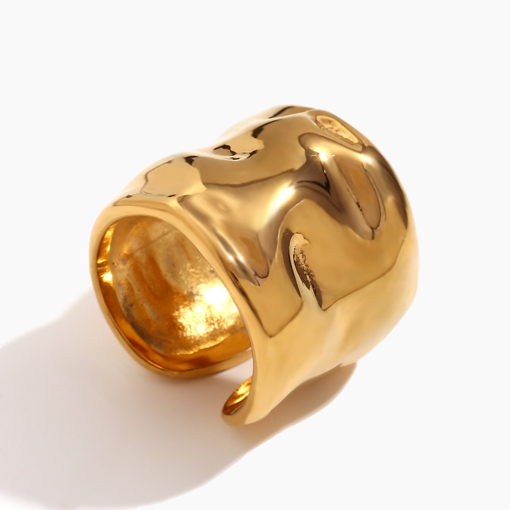 Close-up of molten open cuff ring showing fluid textured metal