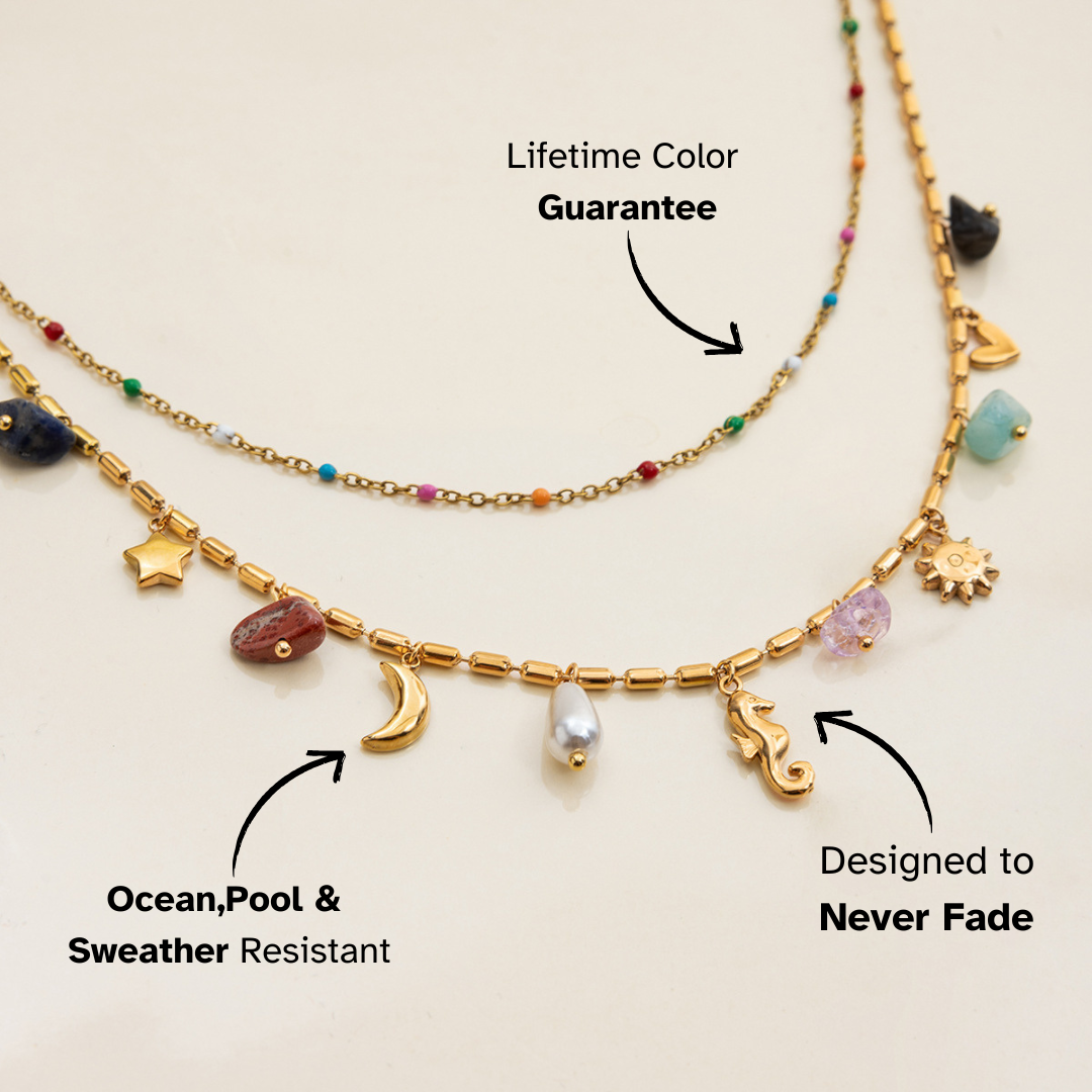Necklace with various charms on a beige background, featuring text about color guarantee and water resistance.