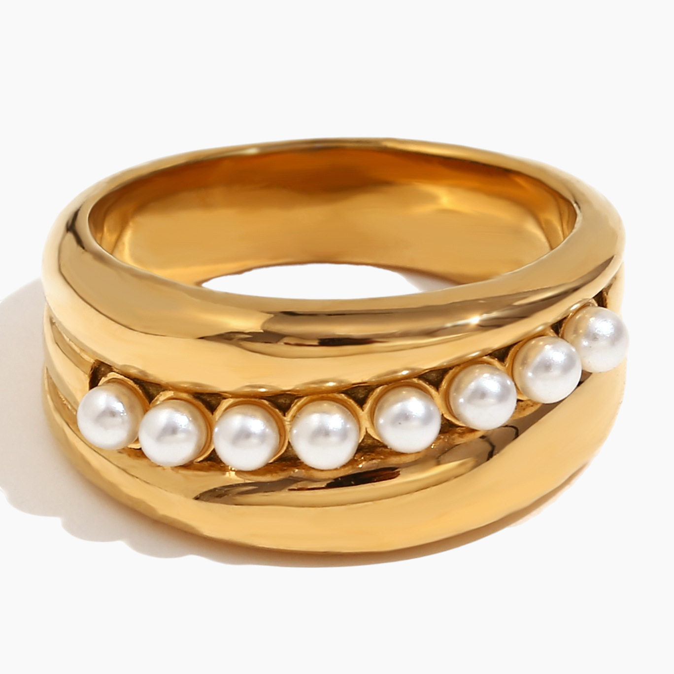 Gold ring with pearls on a white background