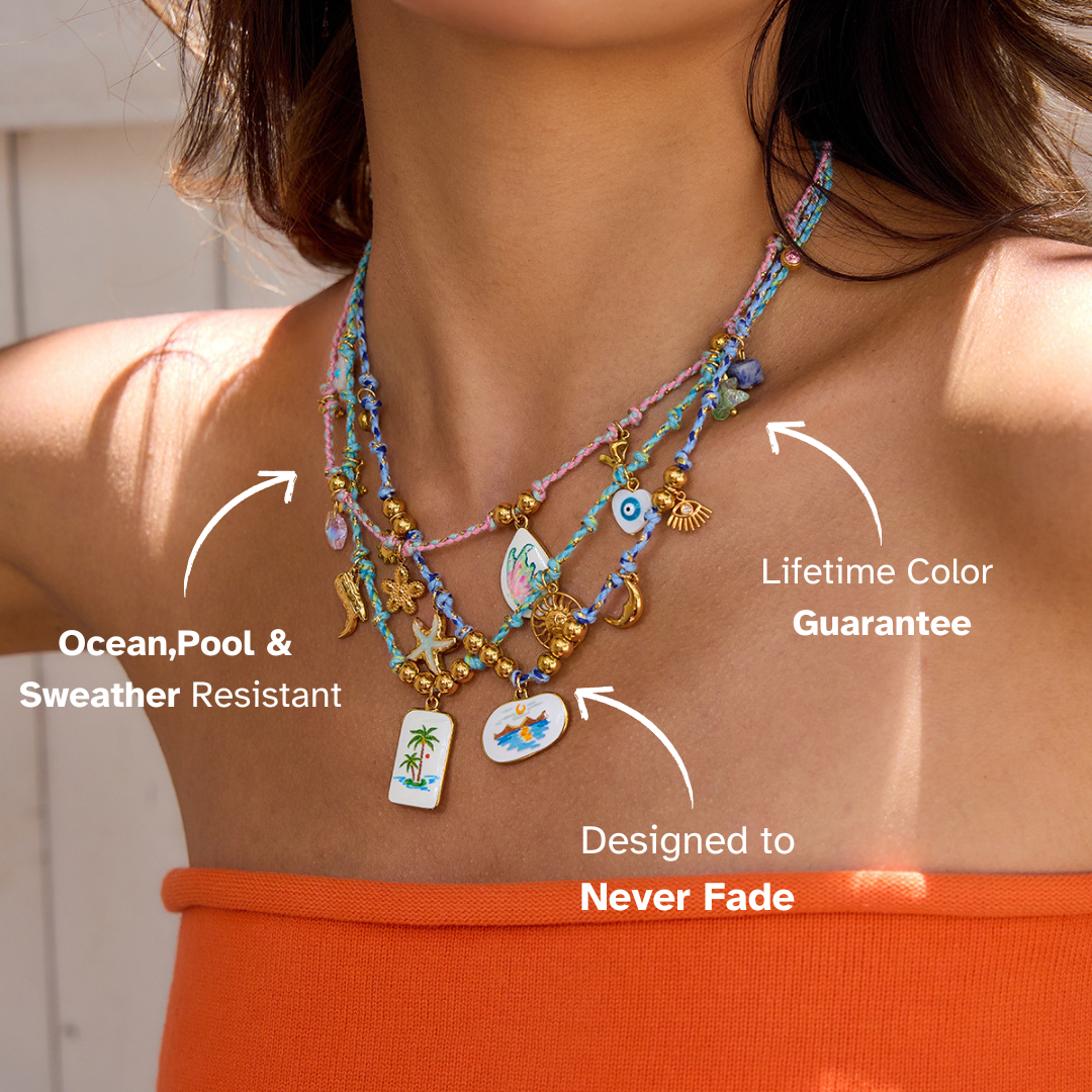 Layered waterproof necklaces on woman in orange tube top