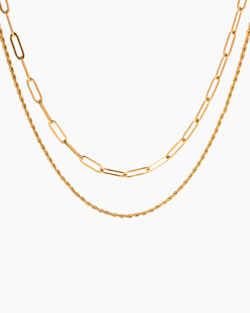 Two gold chains stacked on a white background