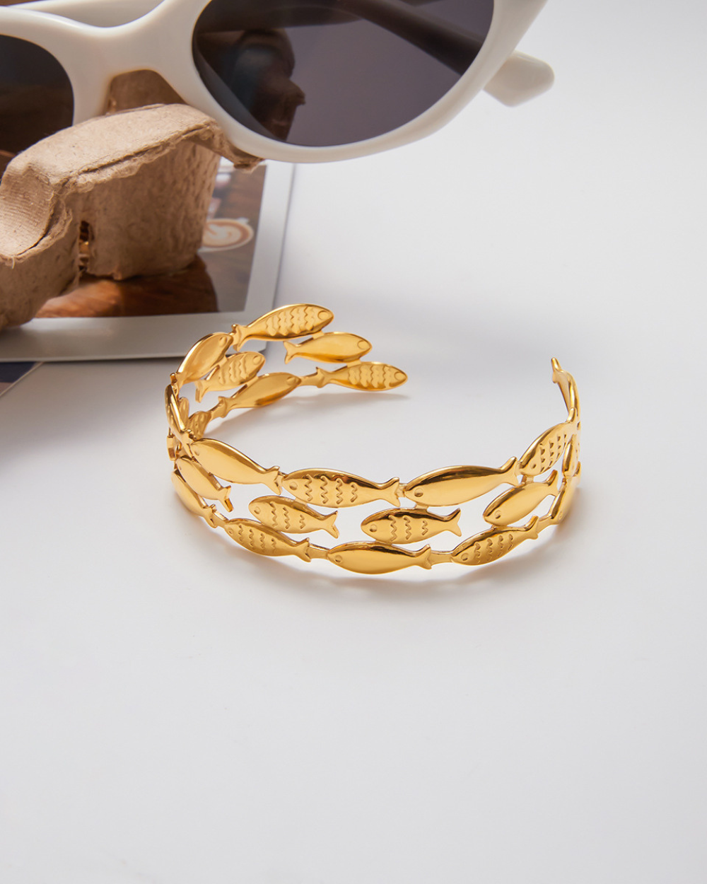 Gold headband with leaf design on a white surface