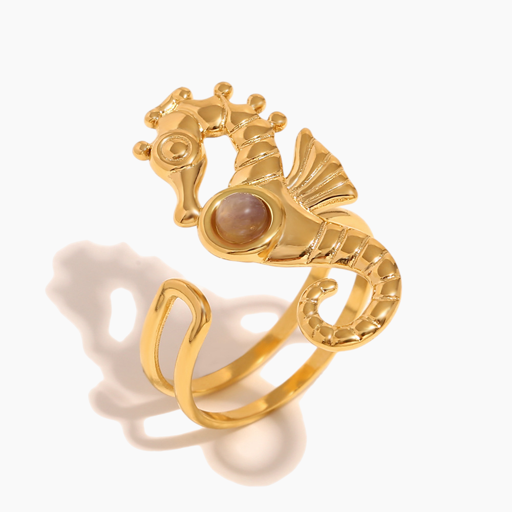 Elegant gold seahorse statement ring catching natural sunlight