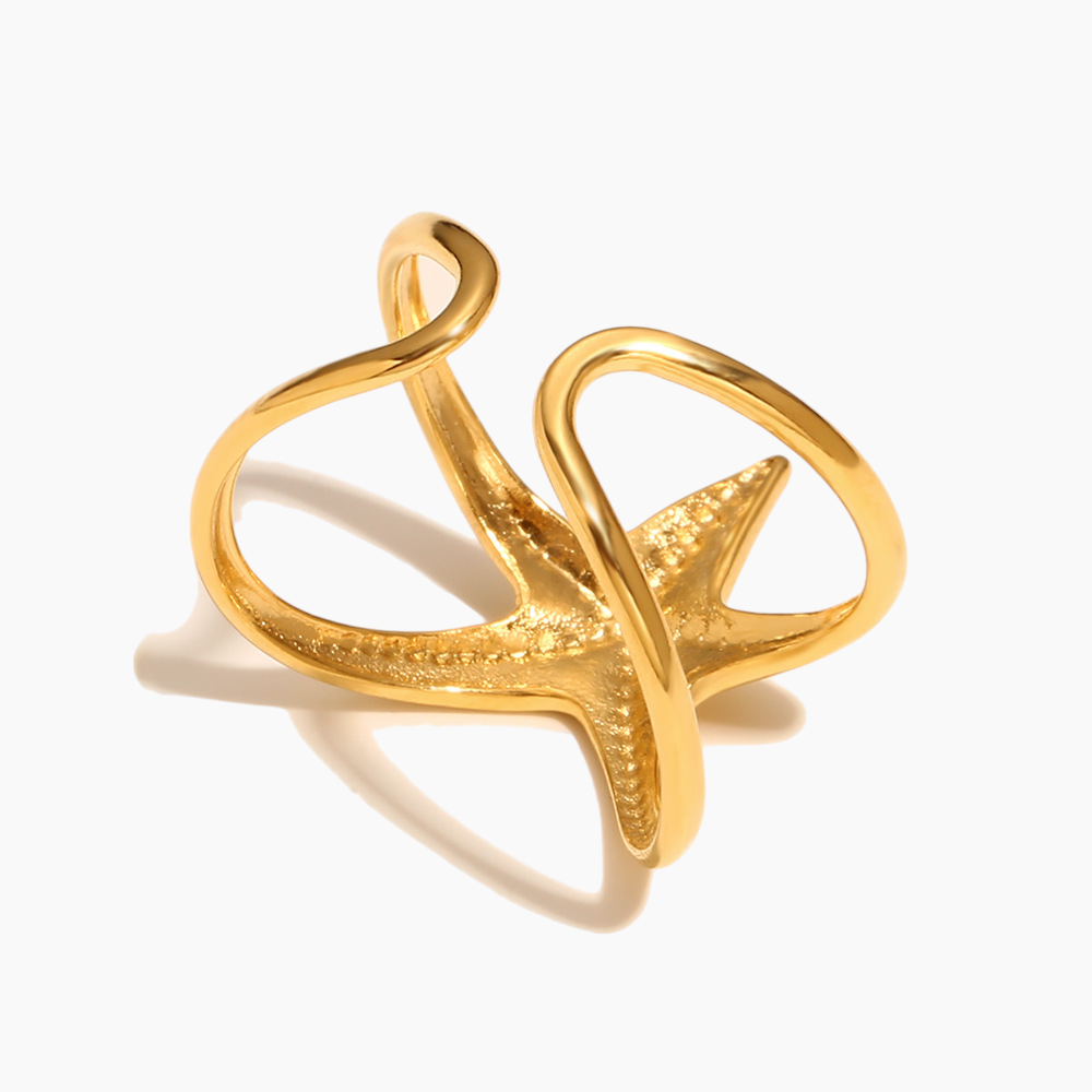 Gold open ring with starfish design on a white background