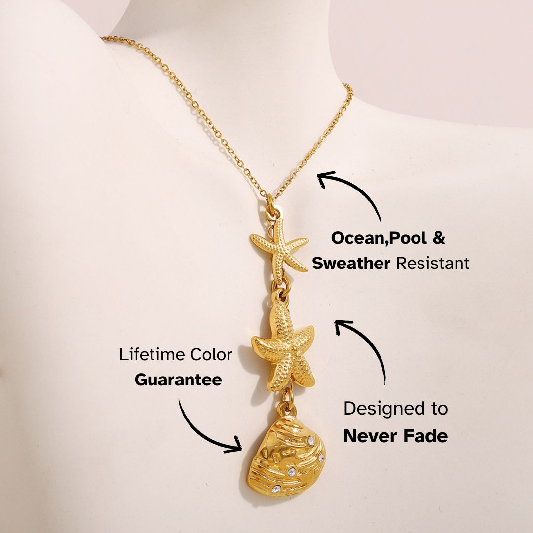 Gold starfish and seashell drop pendant necklace shown on bust display, beach-inspired holiday accessory.