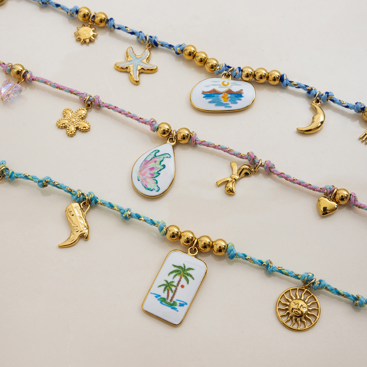 Flatlay of three tropical necklaces with ceramic center charms