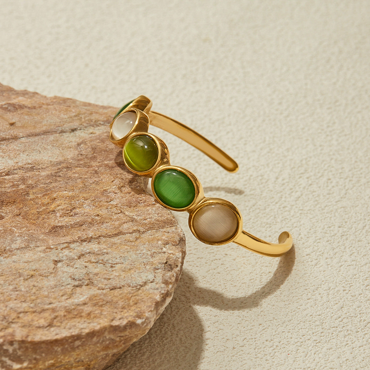 green and cream color mix open bangle styled on natural stone slab