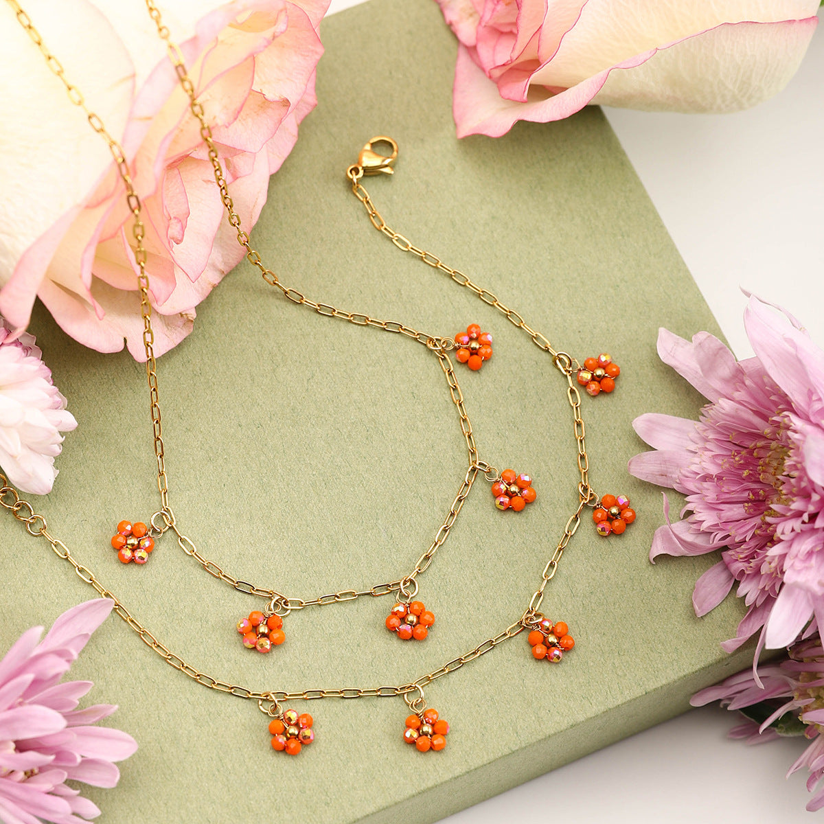 Orange crystal flower necklace close-up with pink rose and gift box