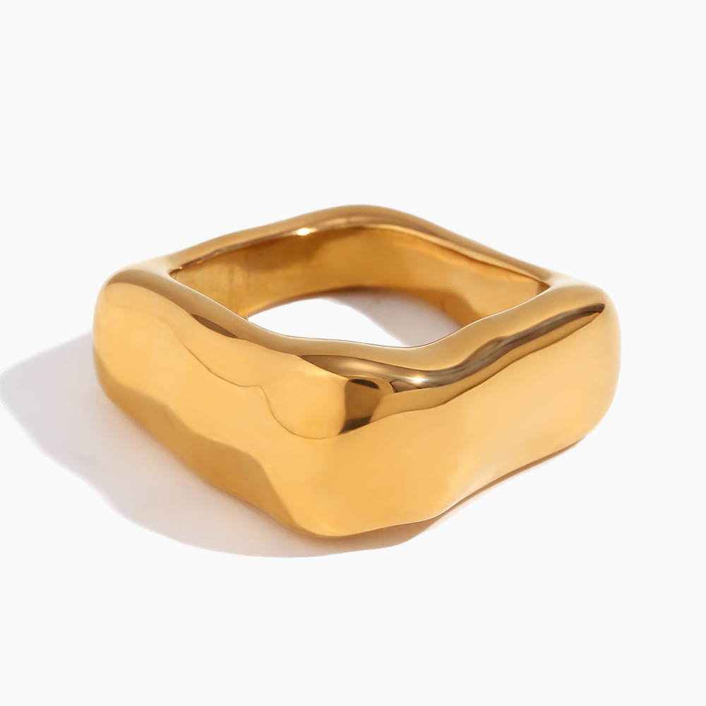 Gold ring with a modern design on a white background