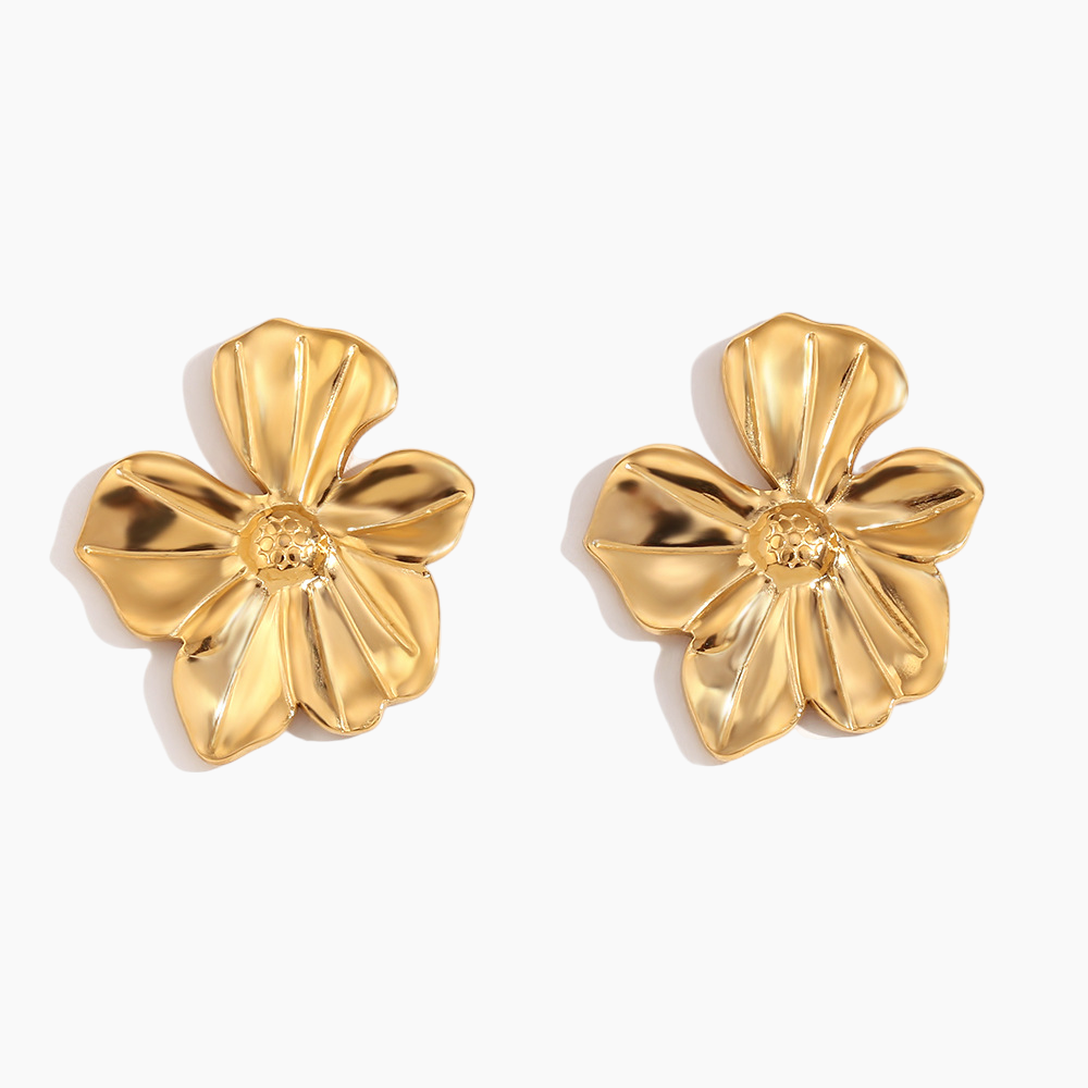 Pair of gold flower-shaped earrings on a white background