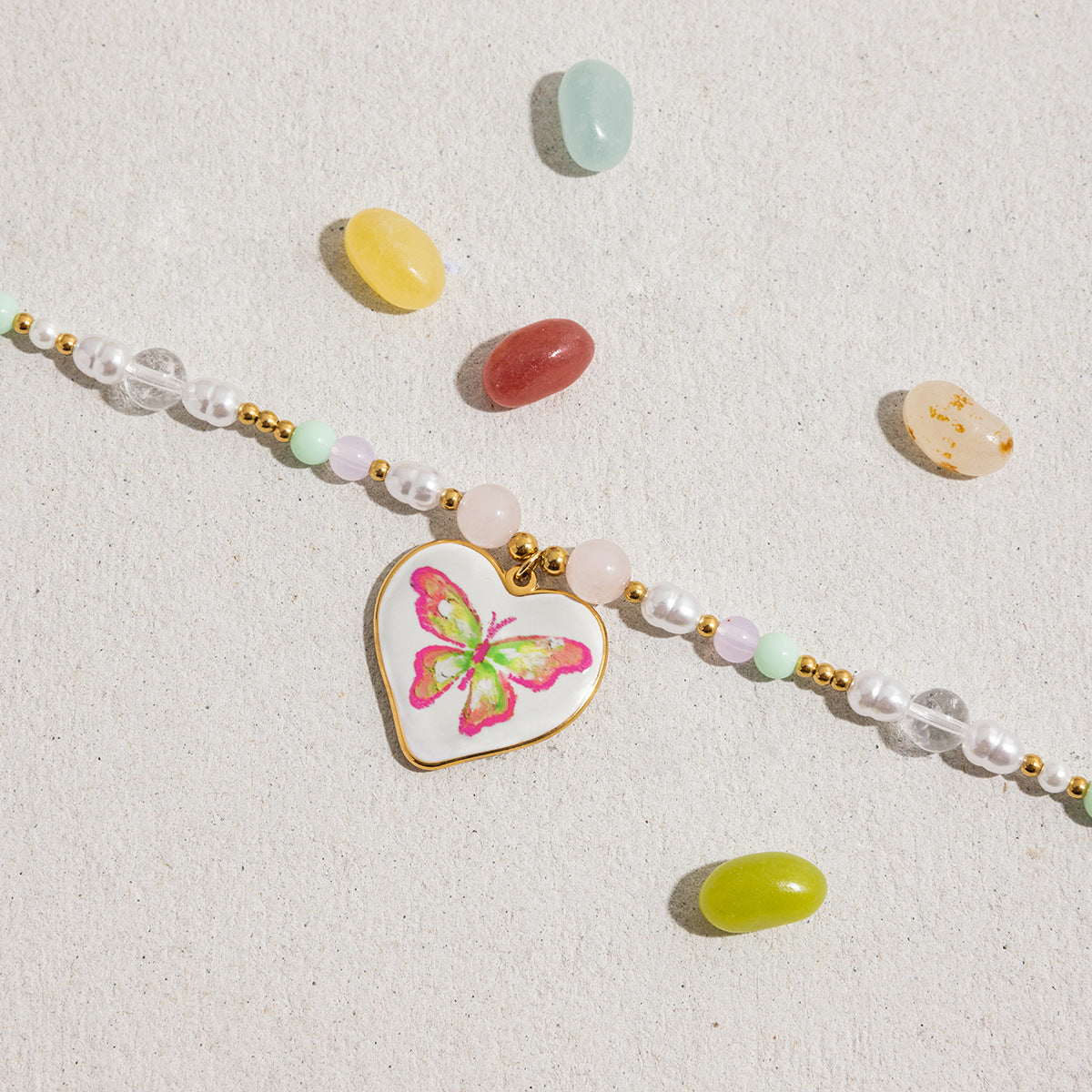 Trendy pastel beaded choker necklace with pink butterfly pendant