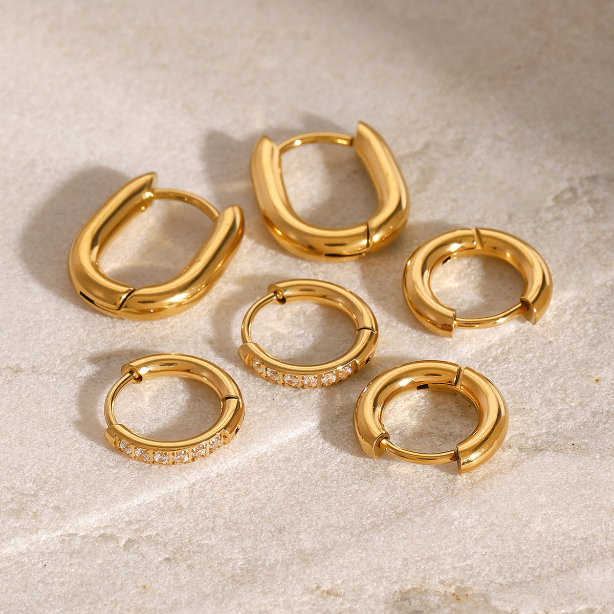 Tiny gold huggie hoops with pavé cubic zirconia