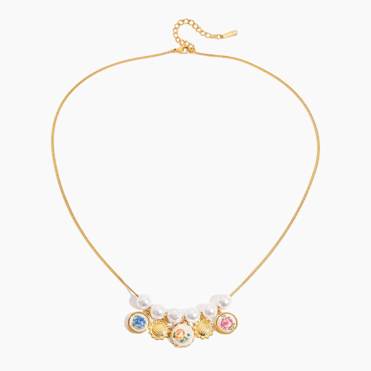 Gold necklace with colorful charms and pearl-like beads on a white background