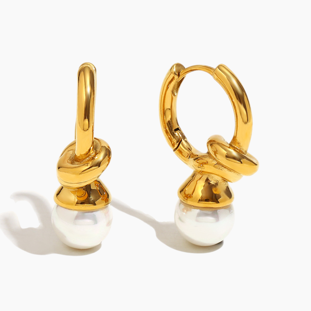 Close-up of gold pearl knot hoop earrings with elegant details