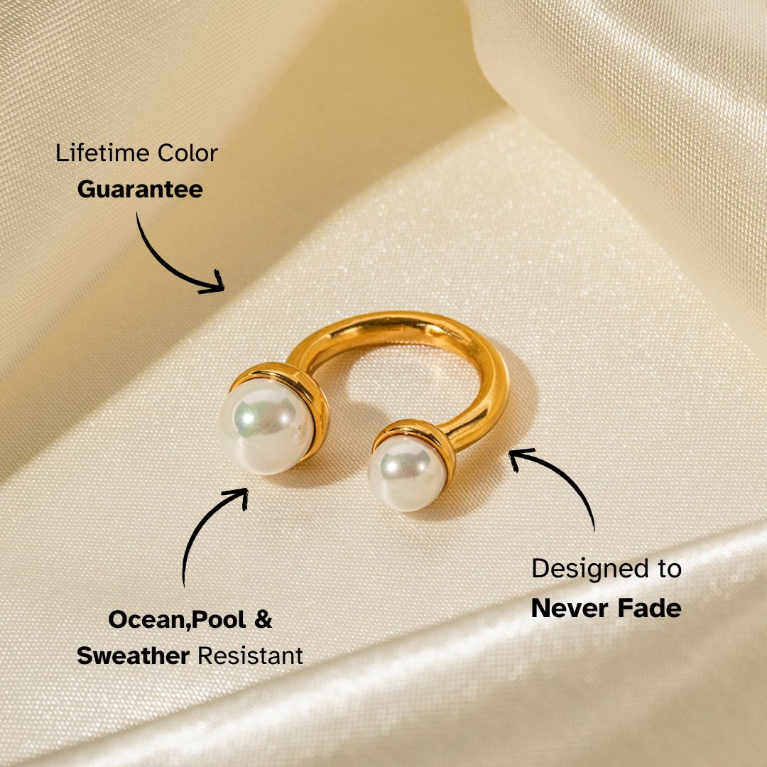 Gold open ring with twin pearls on satin fabric, labeled waterproof and fade-resistant