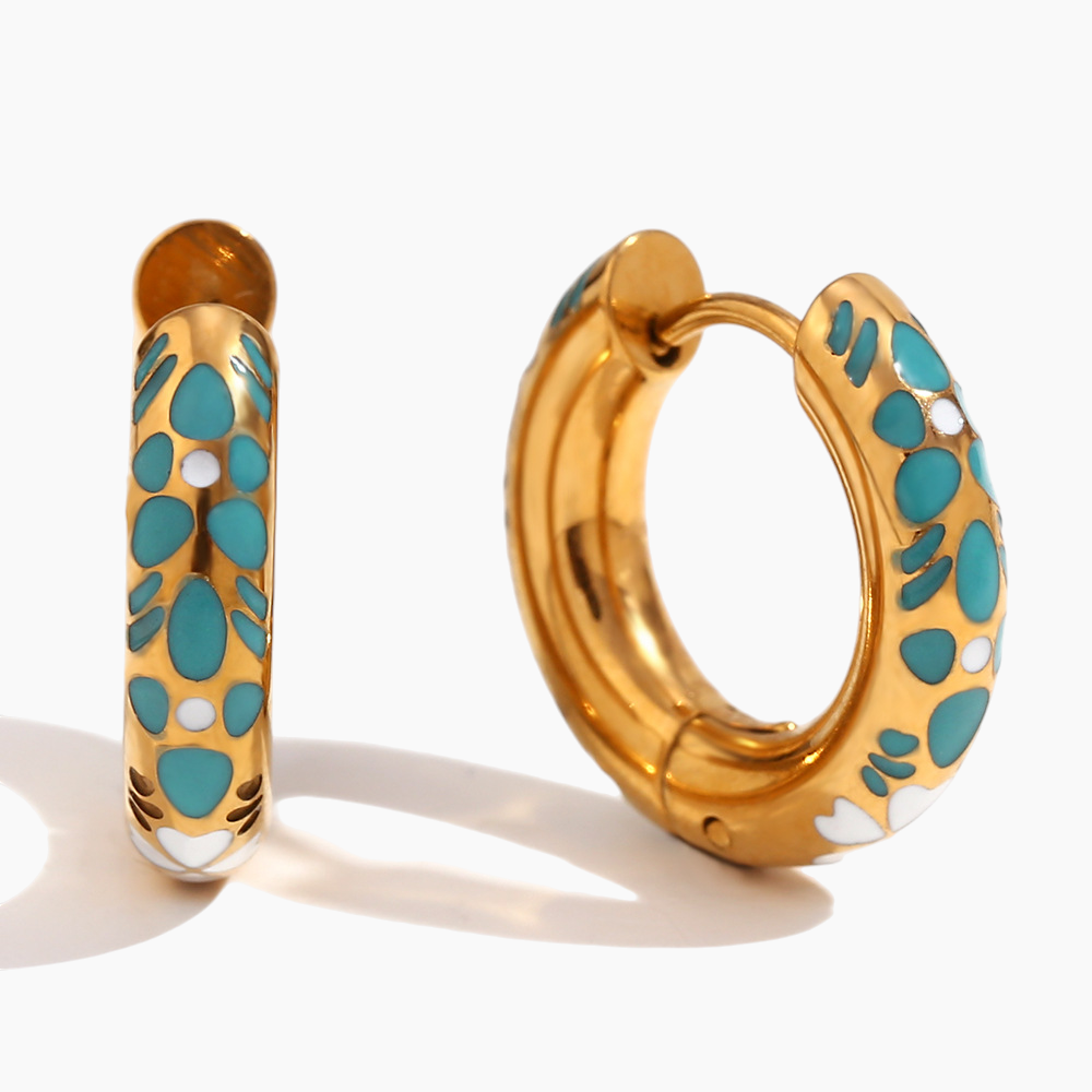 Gold hoop earrings with turquoise and white floral patterns on a white background