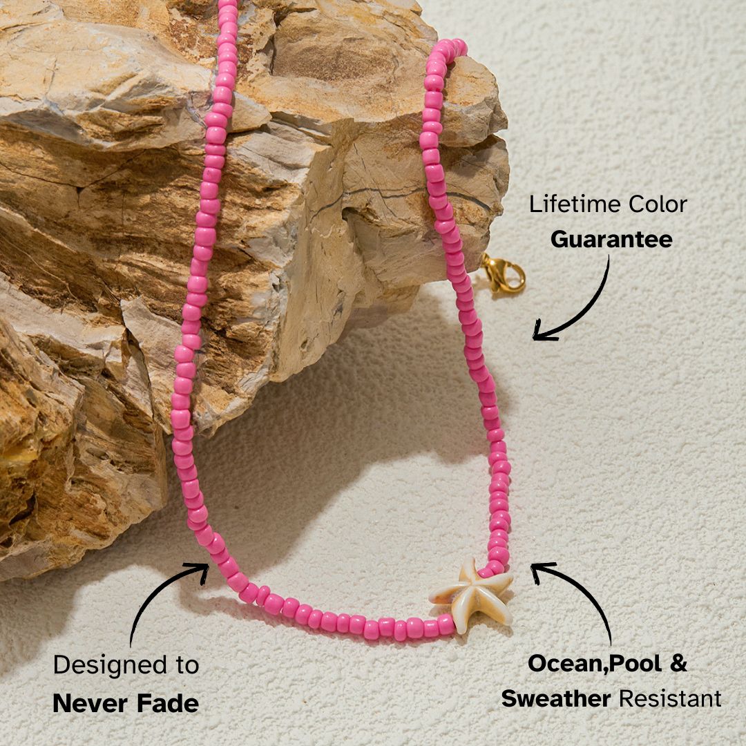 Single starfish pendant hanging from pink bead chain, emphasizing delicate charm and beach vibes.
