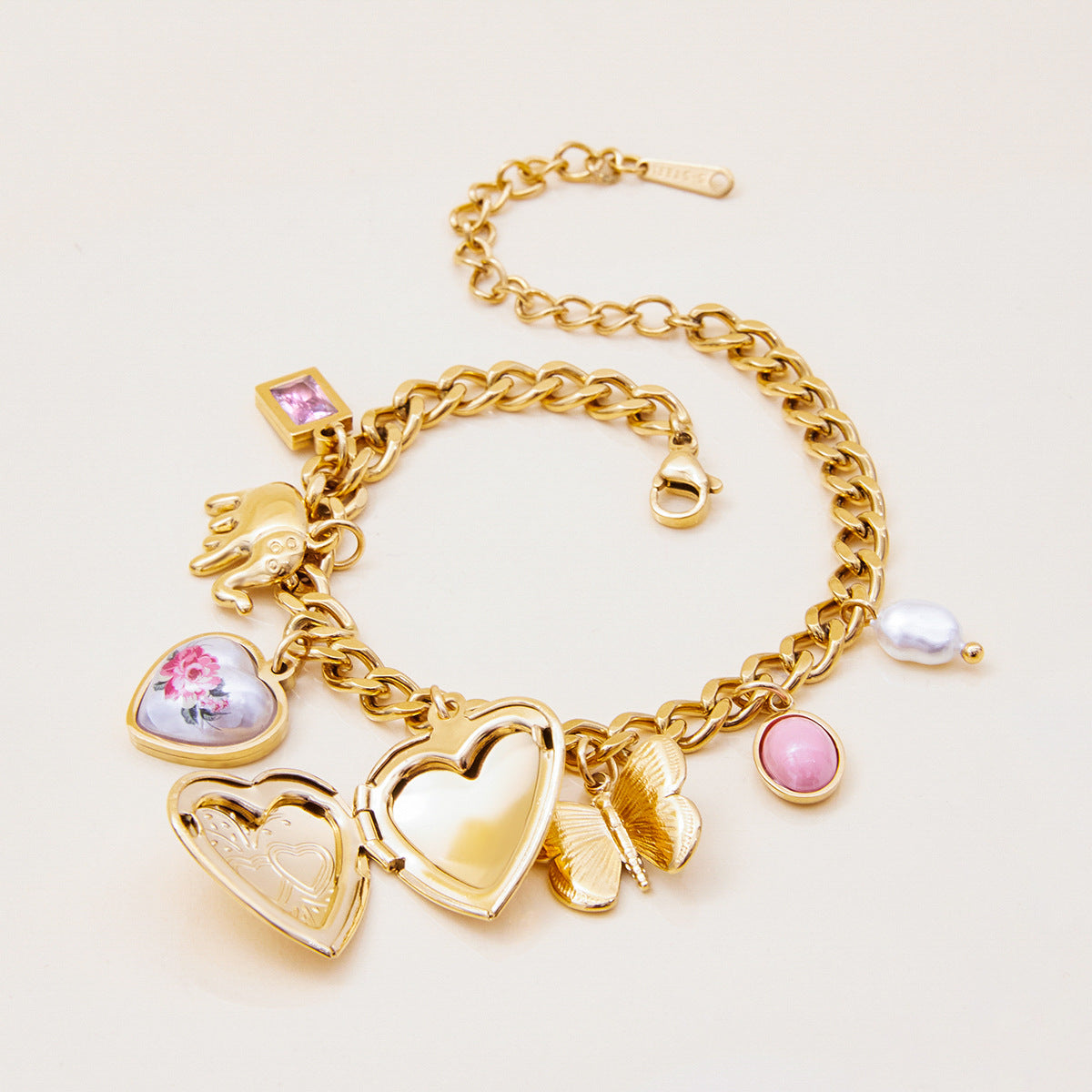 Layered gold bracelet with heart locket and cute charms for women