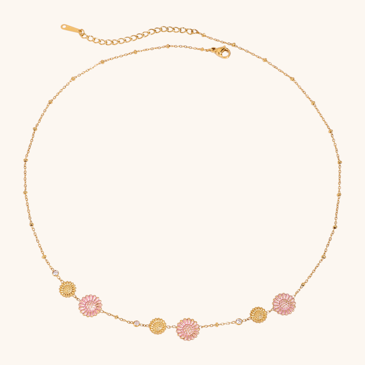 Close-up of pink daisy choker necklace with gold chain