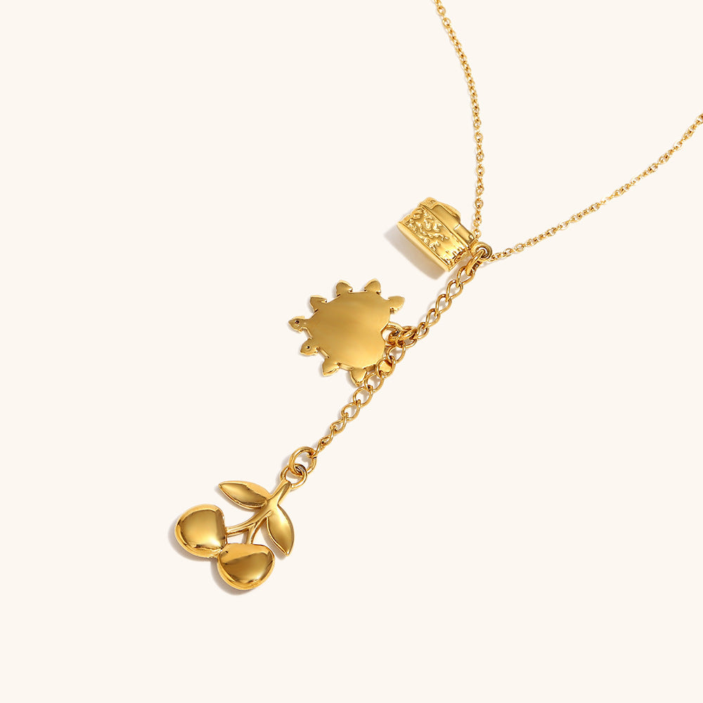 fun gold-tone chain necklace with dangling cherry and heart charms