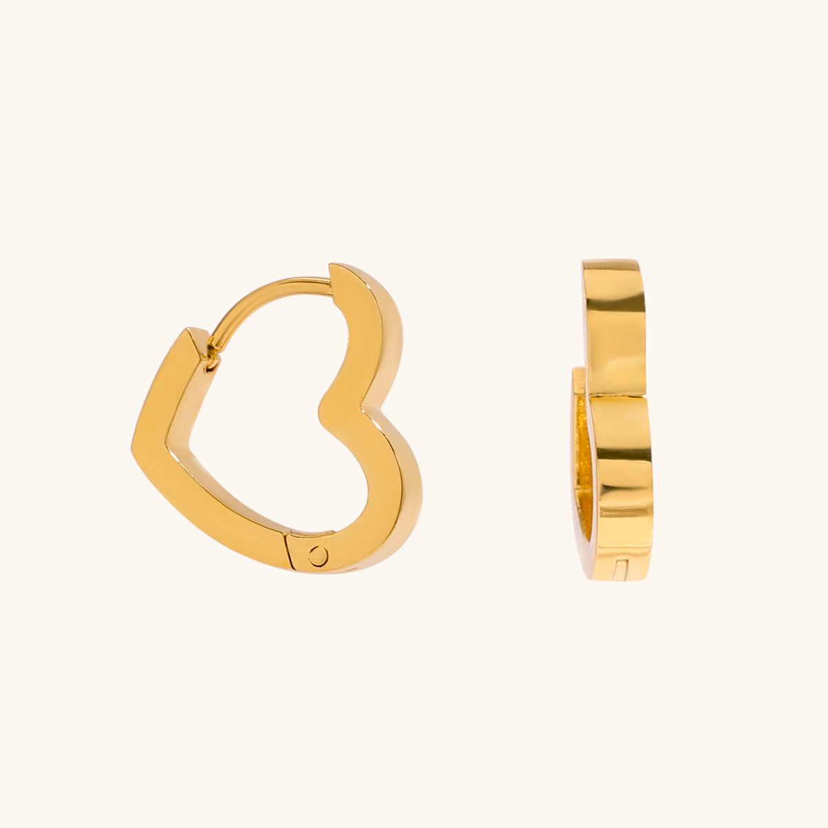 Close-up product shot of golden heart hoop earrings on cream background, minimalist style