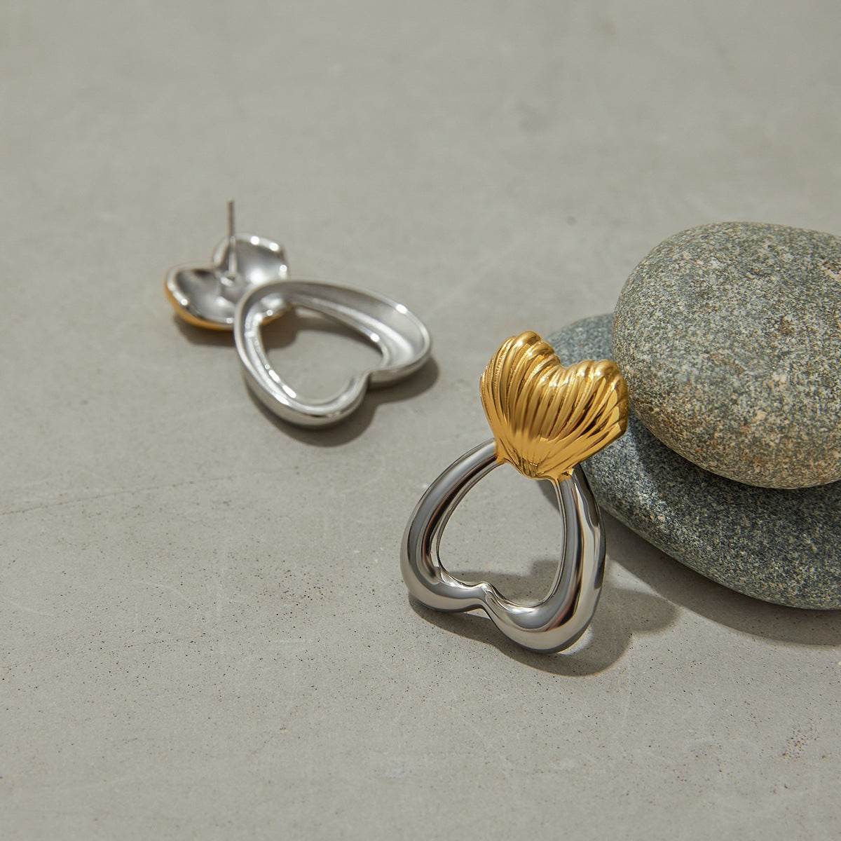 Studio product shot of minimalist sculpted heart earrings