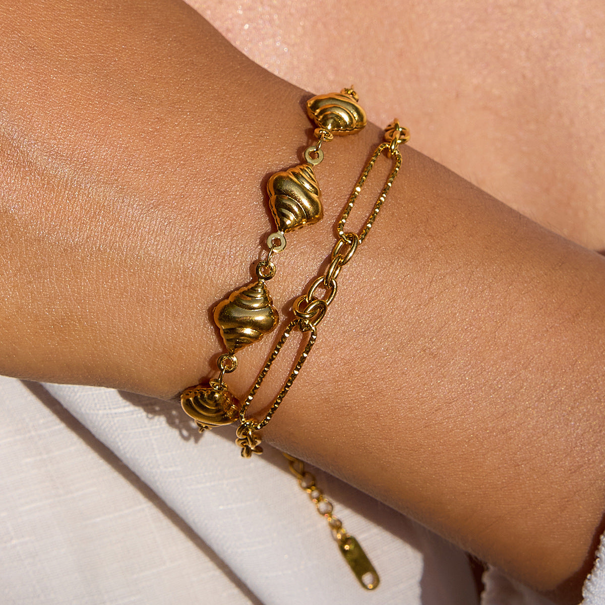 Gold link chain bracelet styled poolside for summer layering look.