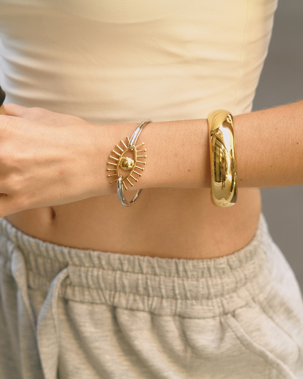 fashion model styling evil eye bracelet with casual chic outfit