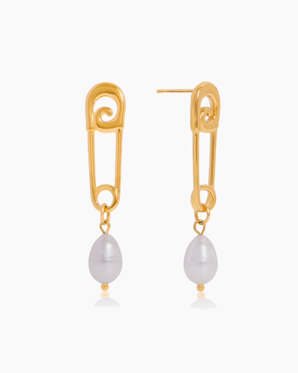 Gold safety pin earrings with pearl drops on a white background