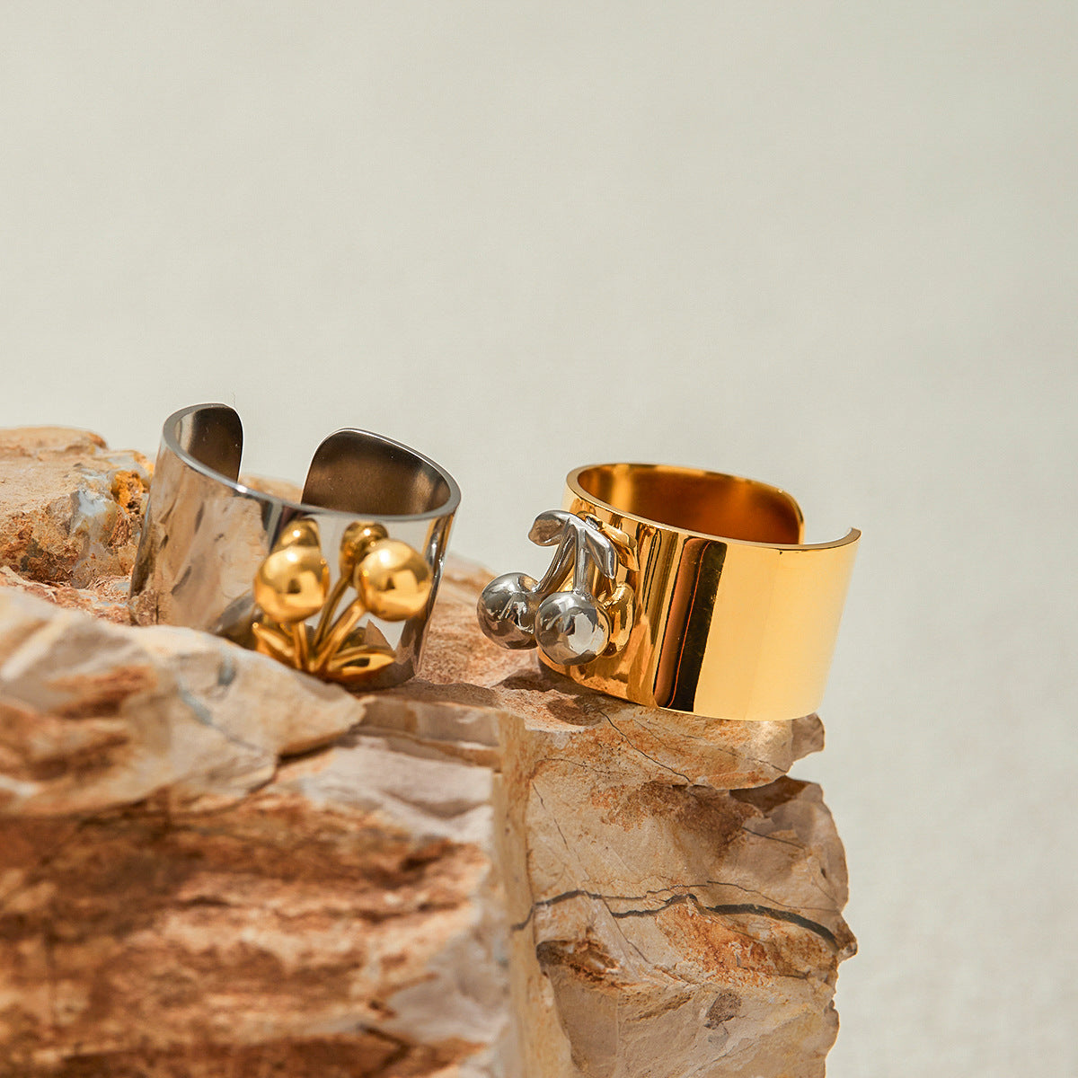 Two-toned cherry rings placed on rocks in natural sunlight