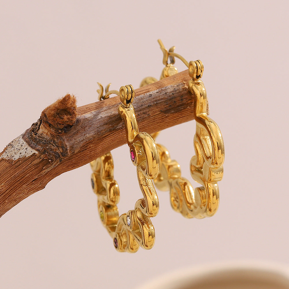 Vintage-style gold earrings with wavy loops and multicolor rhinestones