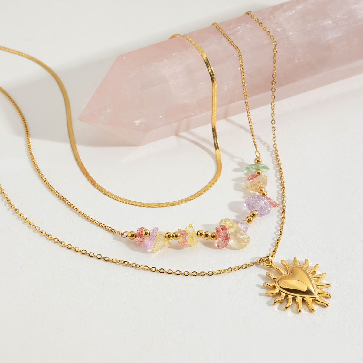 Close-up of gold heart necklace with gemstone detailing