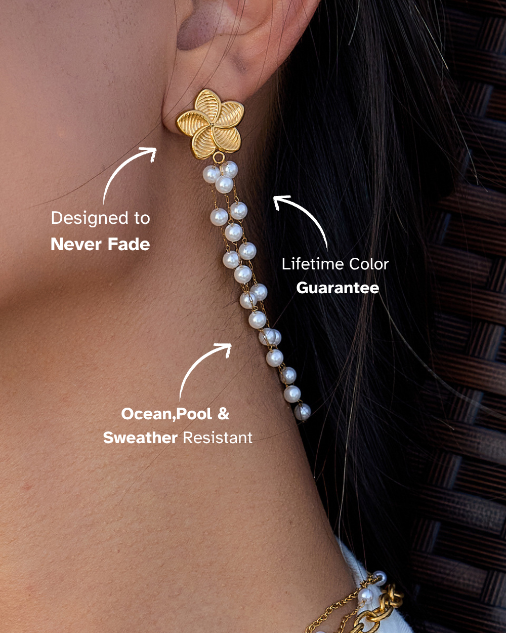 Gold earring with pearl details worn by a person, highlighting features like 'Never Fade', 'Lifetime Color Guarantee', and 'Ocean, Pool & Weather Resistant'.