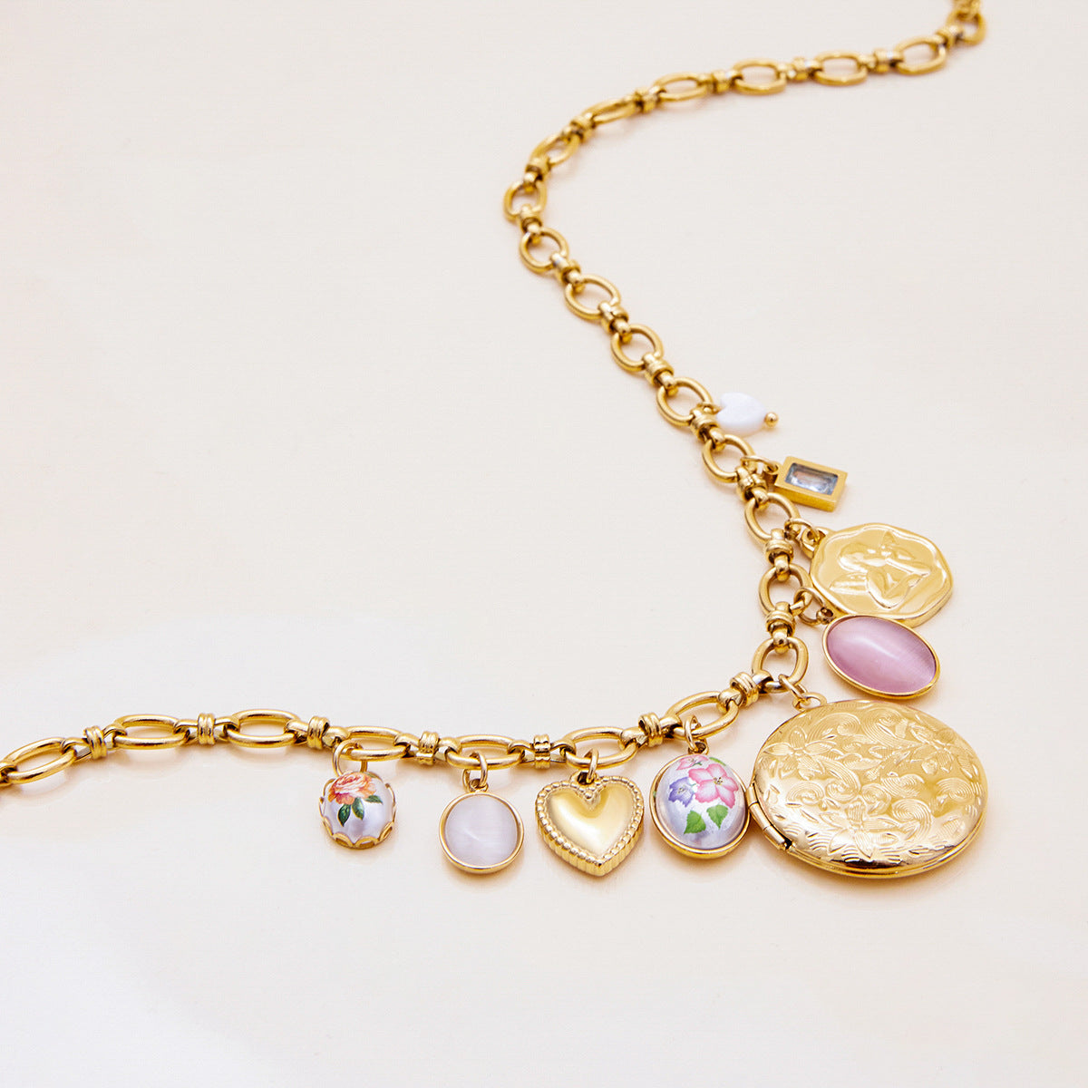 Elegant gold chain necklace with vintage-inspired floral heart pendants