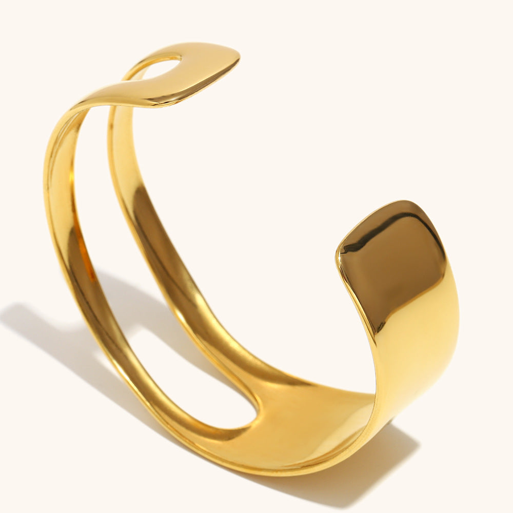 Statement women’s cuff bracelet with sleek hollow center in gold-tone metal