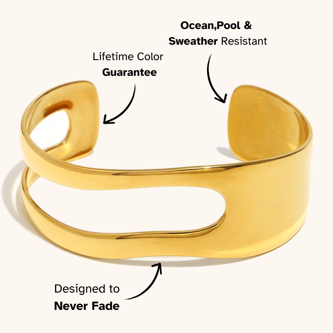 Polished gold open cuff bracelet with minimalist sculptural shape, ideal for modern Parisian outfits.