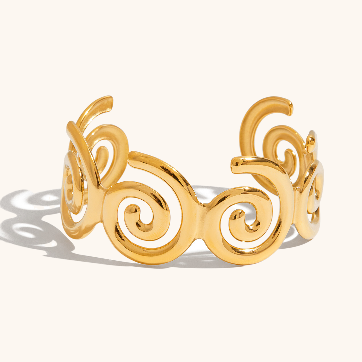 Artistic spiral bracelet in shiny gold finish shot from side view