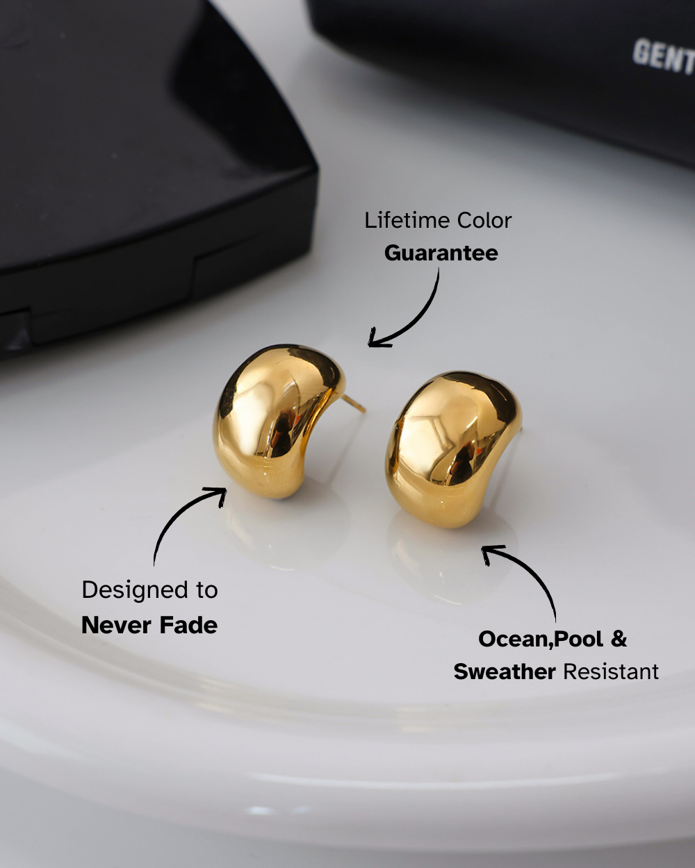 Gold earrings on a white surface with text highlighting features.