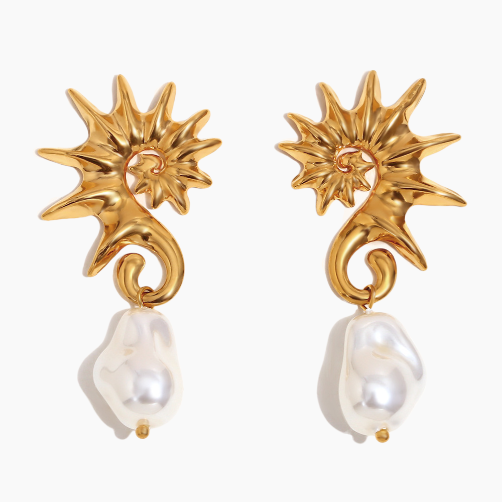 Close-up of seahorse pearl drop earrings with gold-plated finish