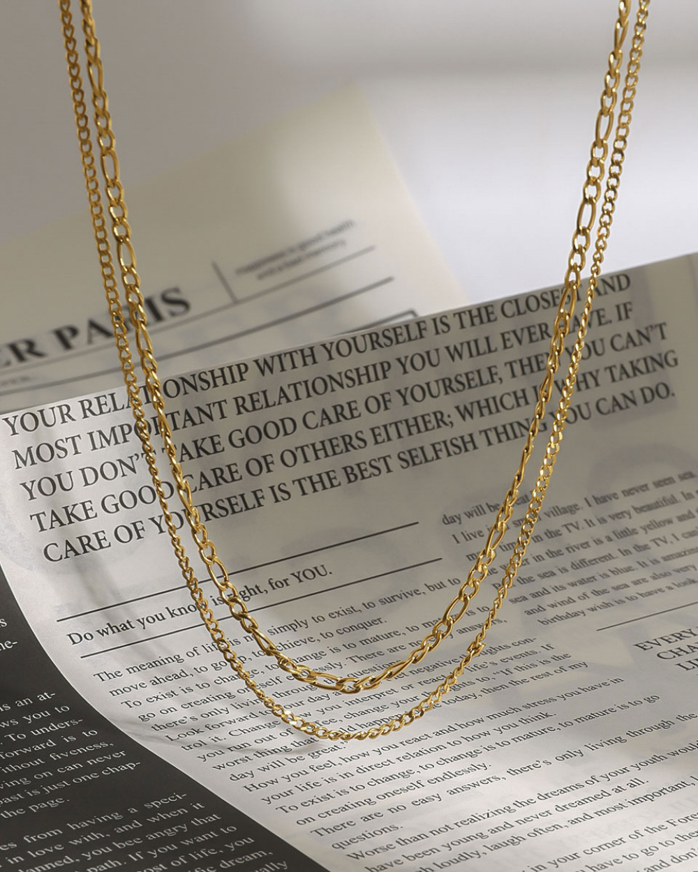 Gold chain necklace on a newspaper background
