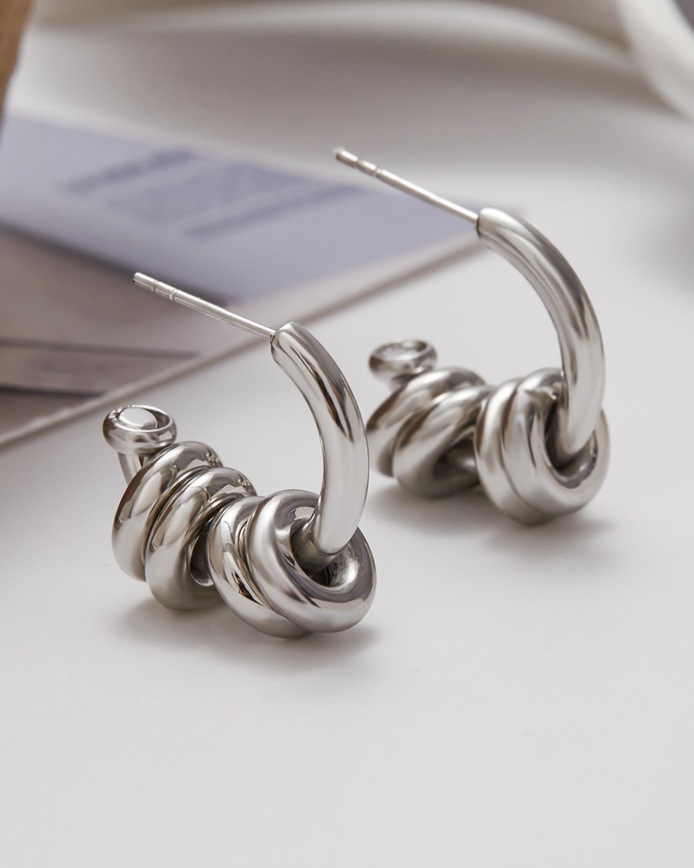 Silver hoop earrings on a light background