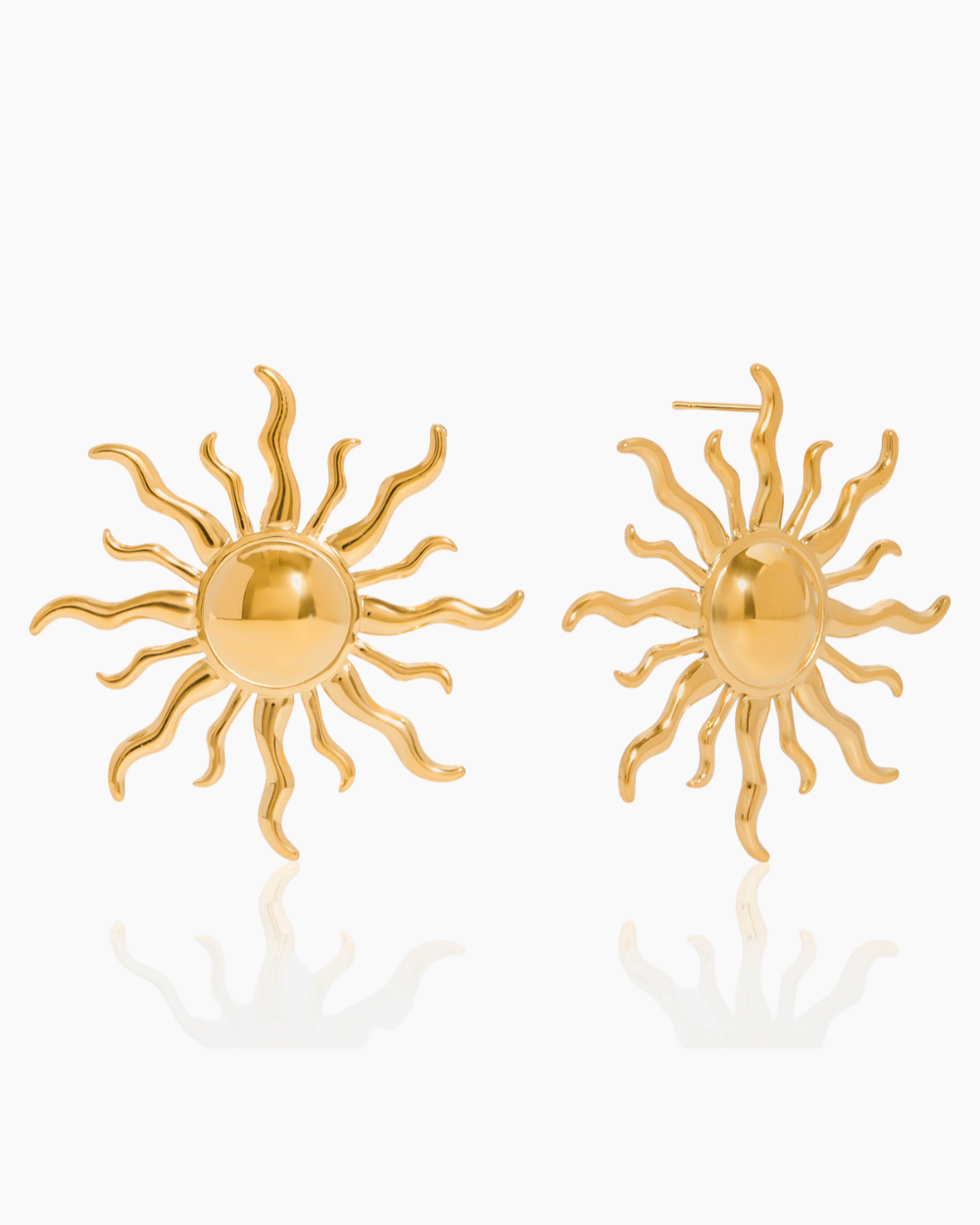 Gold sun-shaped earrings on a white background