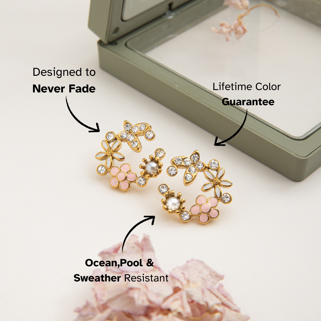 Gold floral earrings with pink accents on a white background, featuring text about durability and warranty.