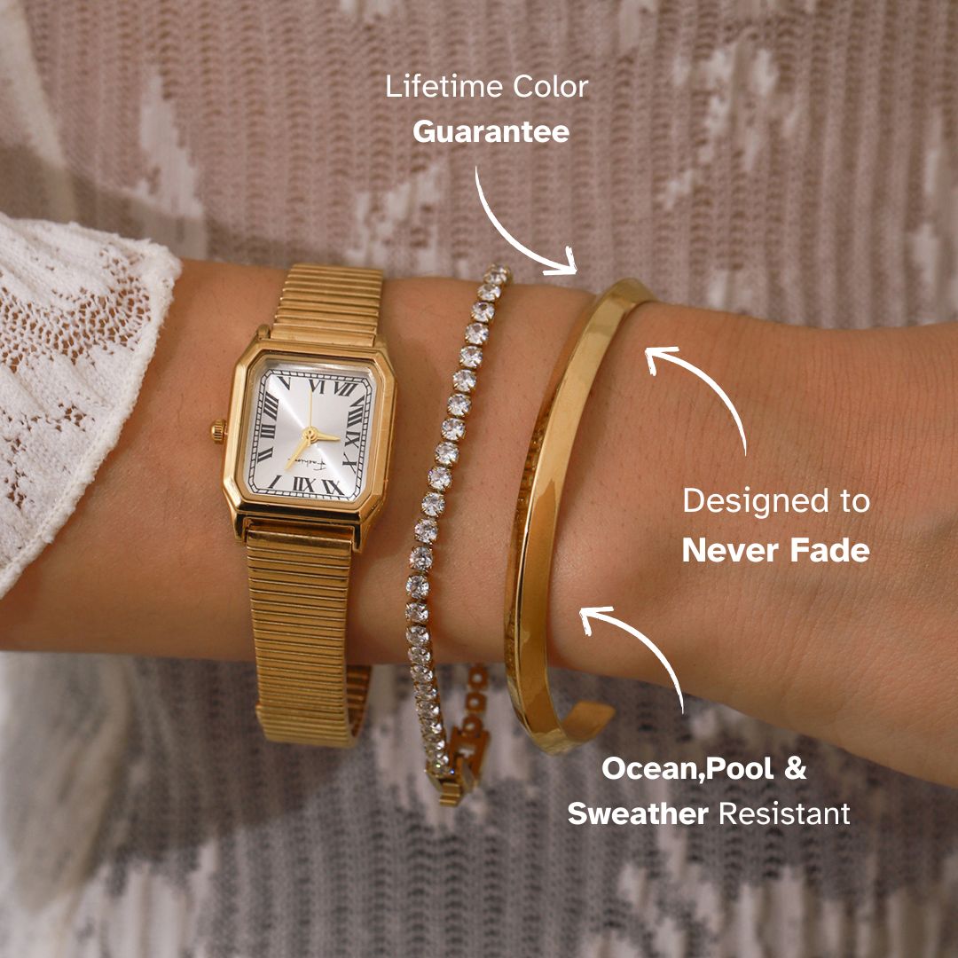 Lifestyle shot of model wearing gold cuff with elegant layering pieces
